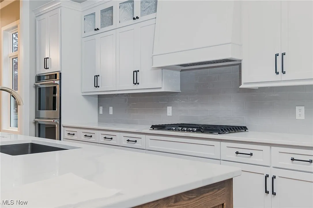 Kitchen with hardwood floors and coffered ceiling details.