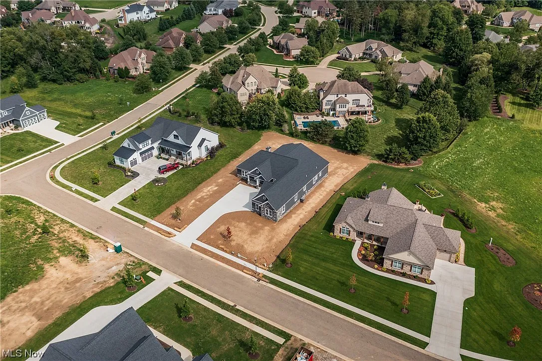 Wider aerial view of the home and lot.